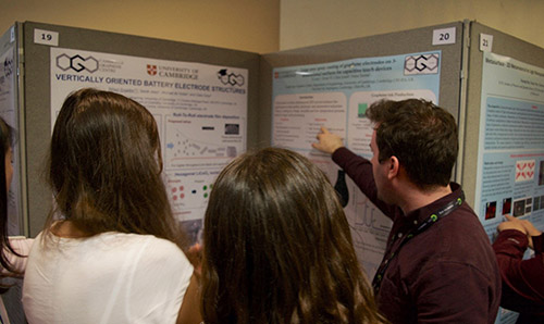 CDT students looking at a poster board at a conference