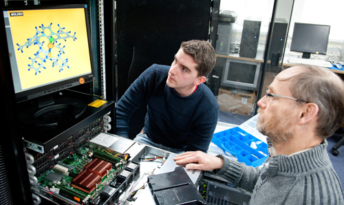Student and professor examining molecules on a computer screen