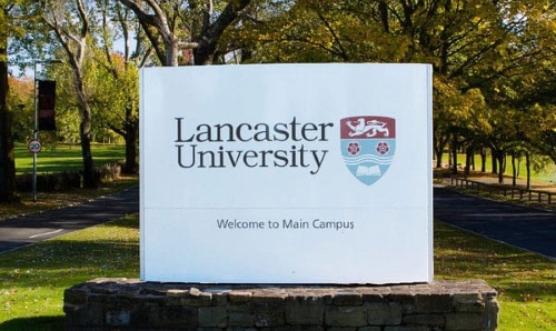 Lancaster university outdoor sign surrounded by greenery